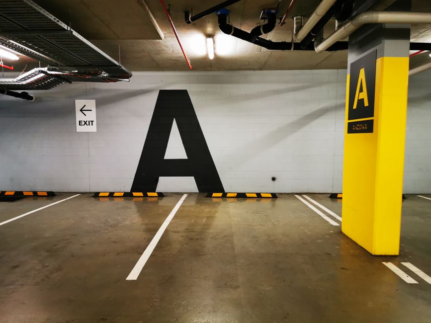 Underground parking space with large letter 'A' and exit sign in Surfers Paradise.